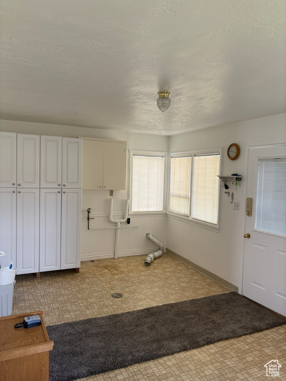 Foyer featuring baseboards and a textured ceiling
