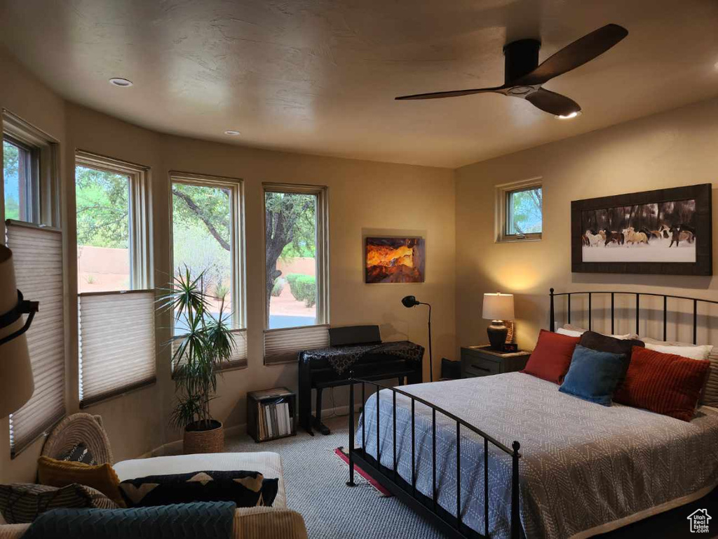 Carpeted bedroom featuring a ceiling fan and recessed lighting