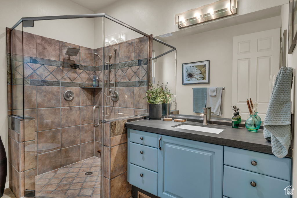 Bathroom with vanity and a shower stall