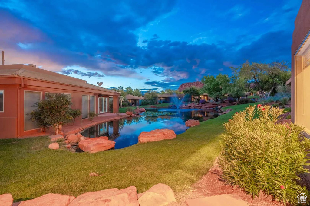 View of pool with a lawn