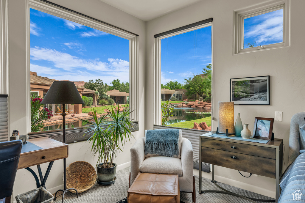 Sitting room featuring carpet flooring and baseboards