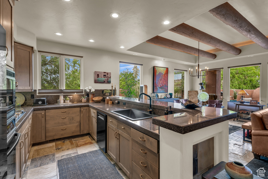 Kitchen with stone tile flooring, tile countertops, recessed lighting, a peninsula, and dishwasher