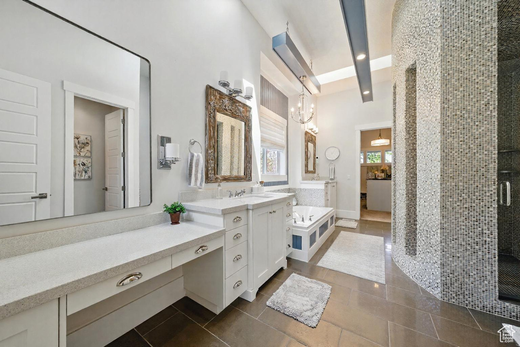 Bathroom with two vanities, a shower stall, tile patterned flooring, and beamed ceiling