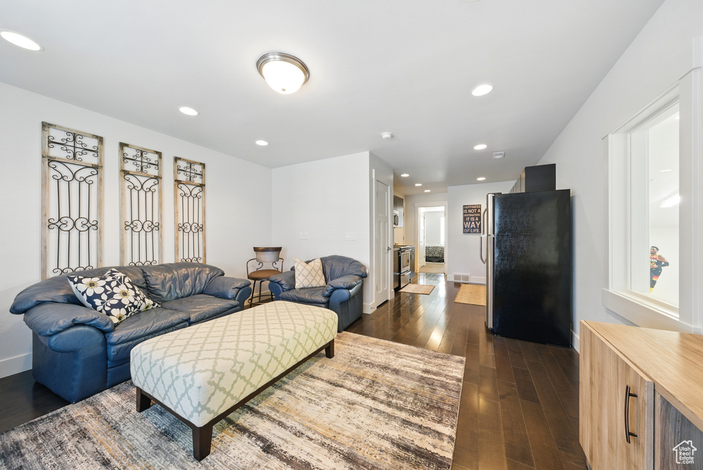 Living room with dark wood-style flooring and recessed lighting