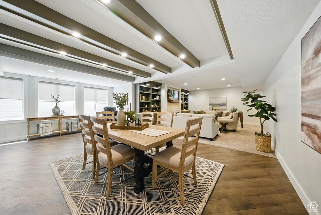 Dining area with wood finished floors, beamed ceiling, and recessed lighting