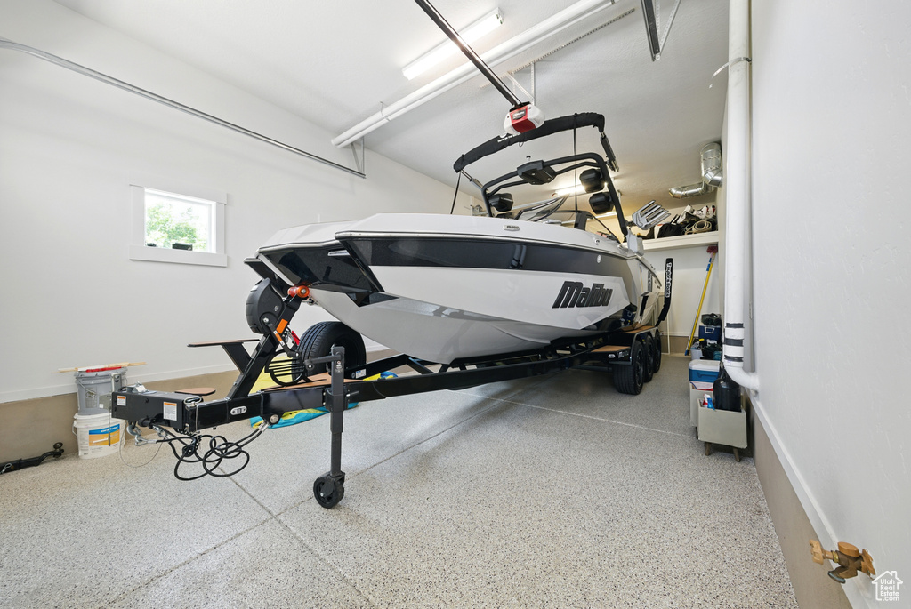 Garage with a garage door opener and baseboards