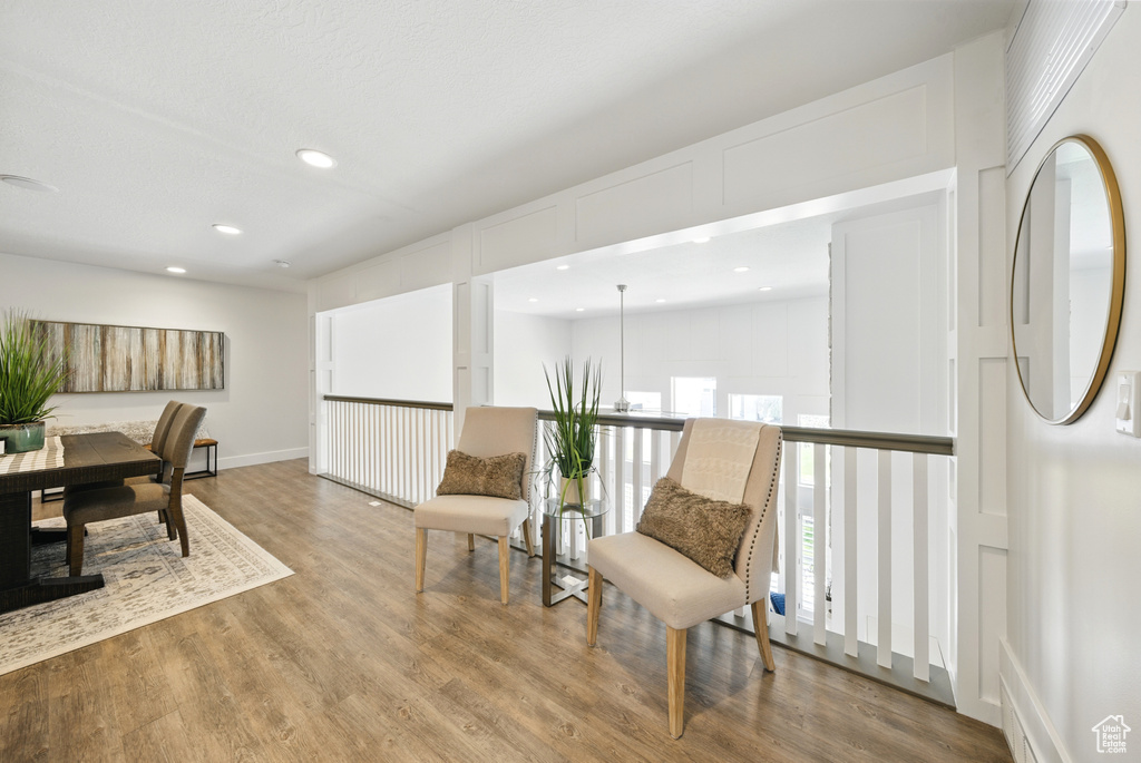 Sitting room with wood finished floors and recessed lighting