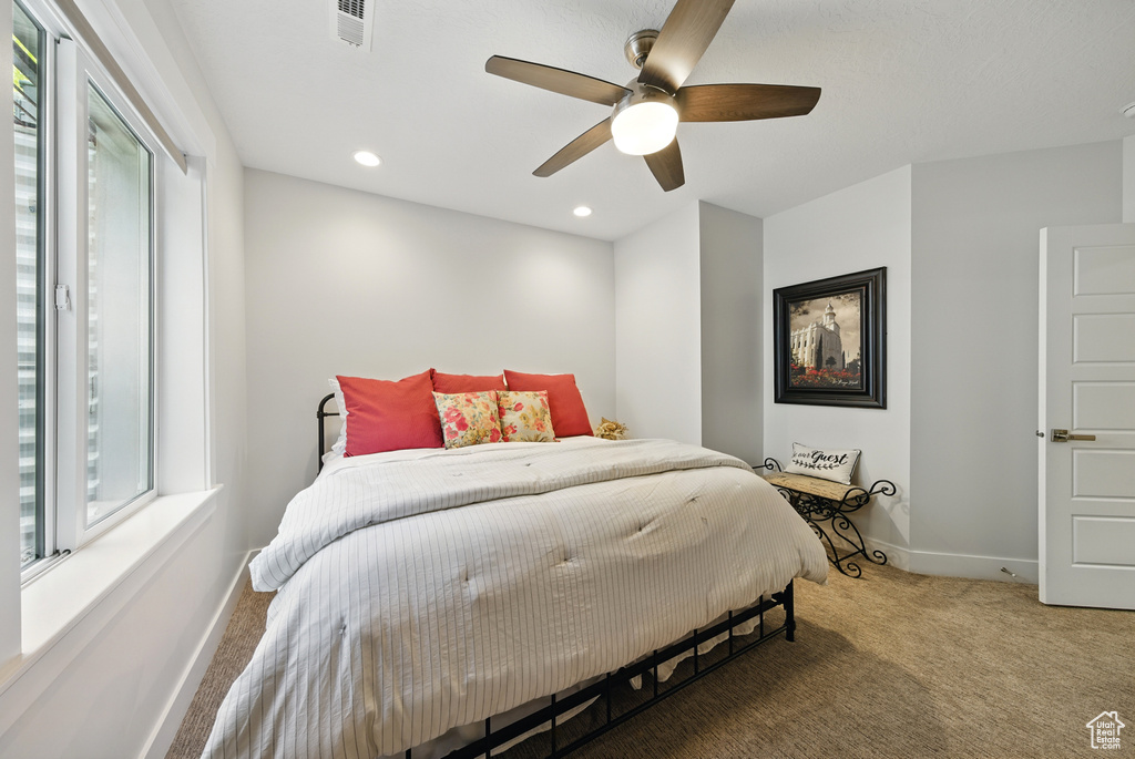 Bedroom featuring carpet flooring, multiple windows, recessed lighting, and ceiling fan