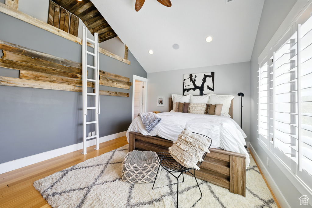 Bedroom with lofted ceiling, wood finished floors, and recessed lighting