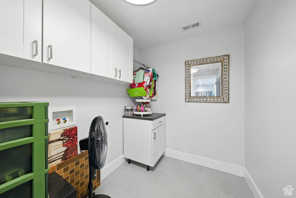 Laundry area with cabinet space, hookup for a washing machine, and electric dryer hookup