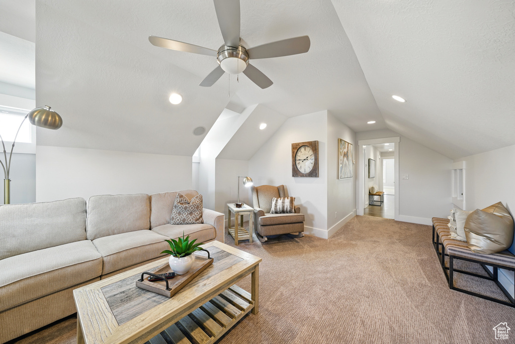 Living area featuring carpet flooring, a ceiling fan, recessed lighting, and lofted ceiling