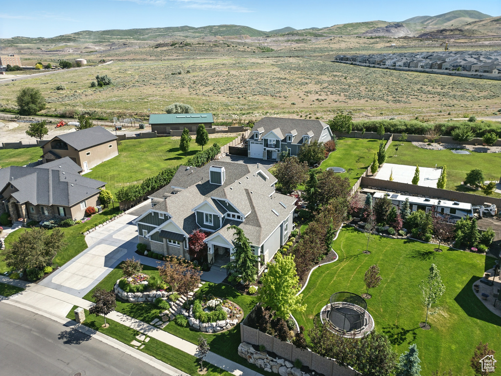Aerial perspective of suburban area featuring a mountainous background