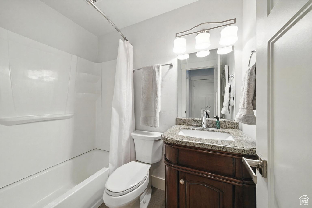 Bathroom with shower / bathtub combination with curtain and vanity