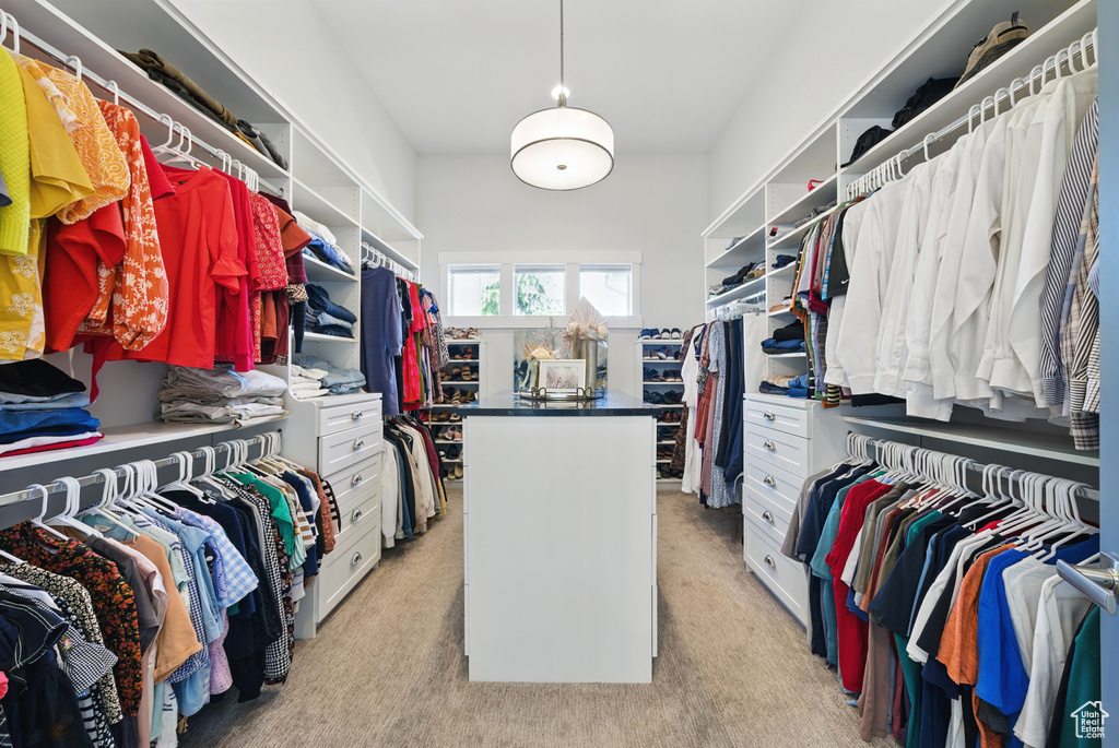 Walk in closet featuring light colored carpet