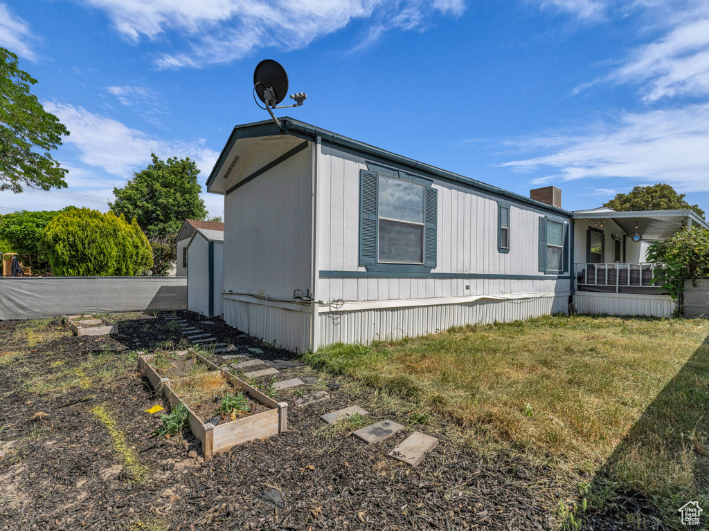 View of side of property featuring a vegetable garden