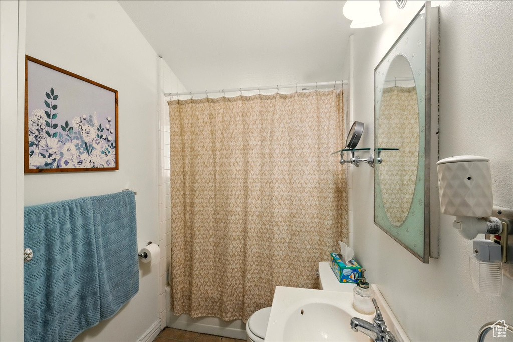 Bathroom featuring toilet and shower / tub combo