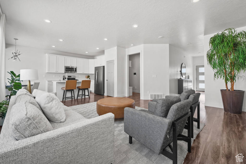 Living area with recessed lighting and dark wood finished floors
