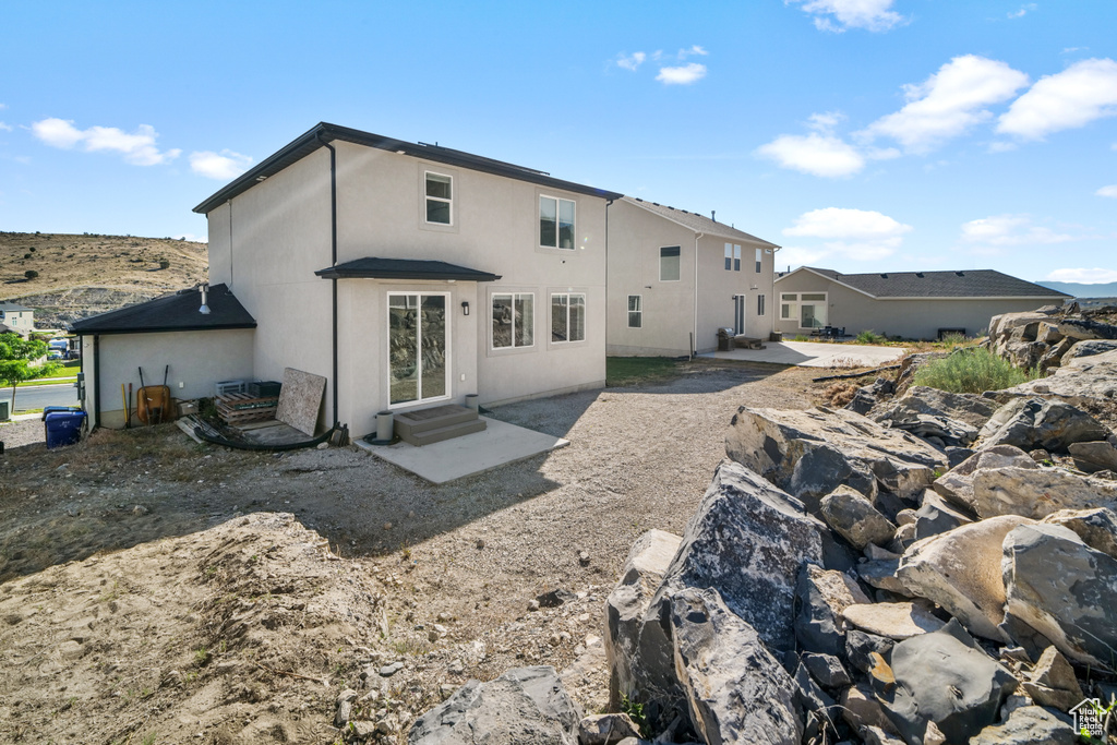 Back of house featuring a patio area, stucco siding, and entry steps