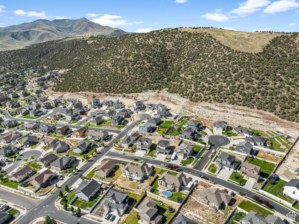 Aerial overview of property\'s location with a mountain backdrop and nearby suburban area
