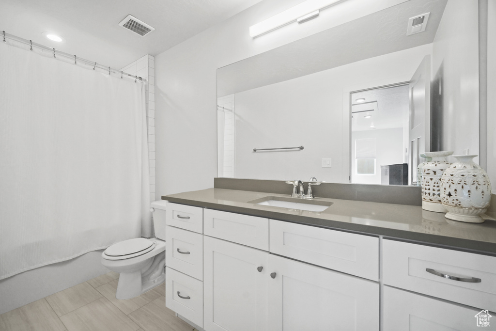 Full bathroom featuring vanity and shower / bathtub combination with curtain
