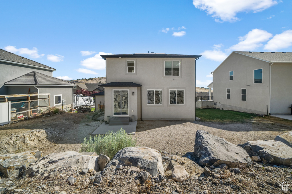 Back of property featuring stucco siding