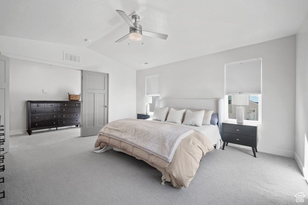 Bedroom with carpet, vaulted ceiling, and ceiling fan