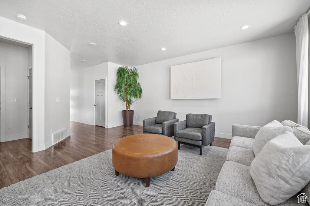 Living room with wood finished floors and recessed lighting