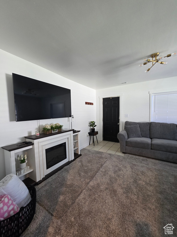 Tiled living room with a chandelier and carpet floors