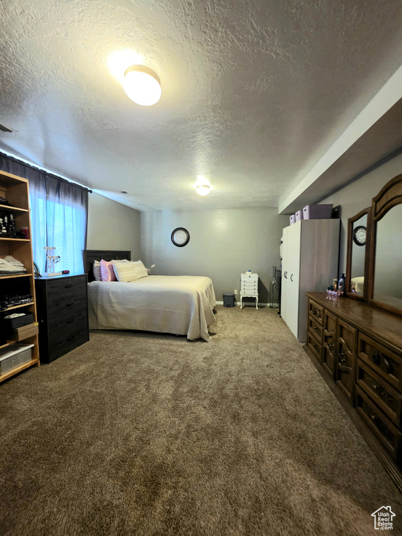 Bedroom featuring a textured ceiling and carpet flooring