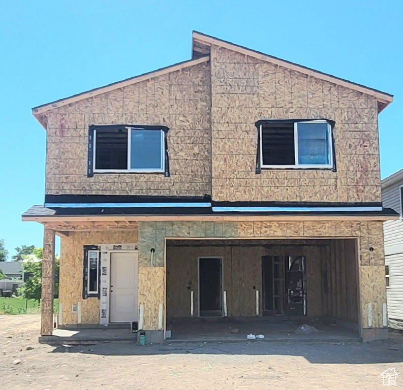 View of front of property with an attached garage and driveway