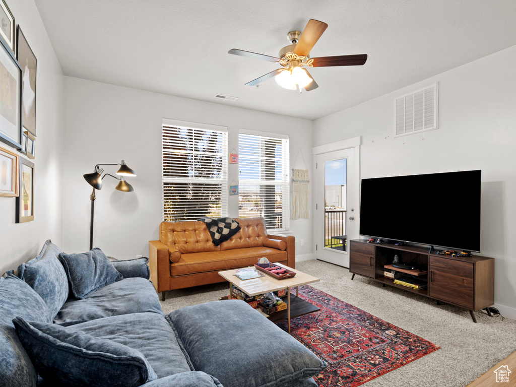 Living room with ceiling fan and baseboards