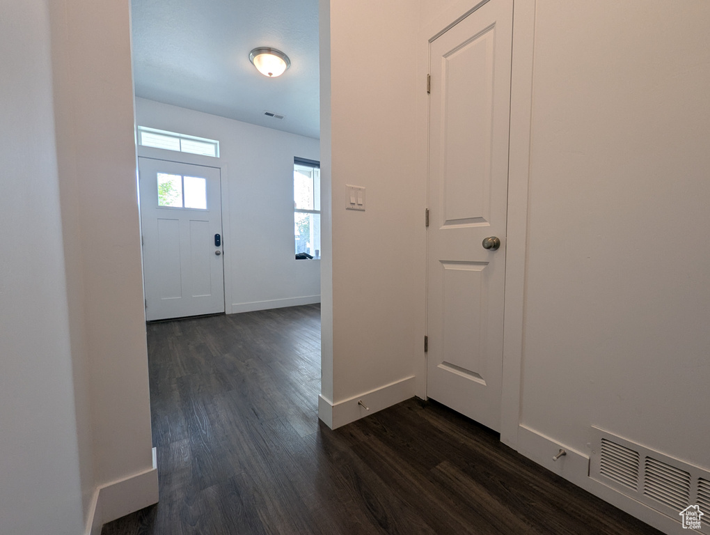 Entrance foyer featuring dark wood-type flooring and baseboards