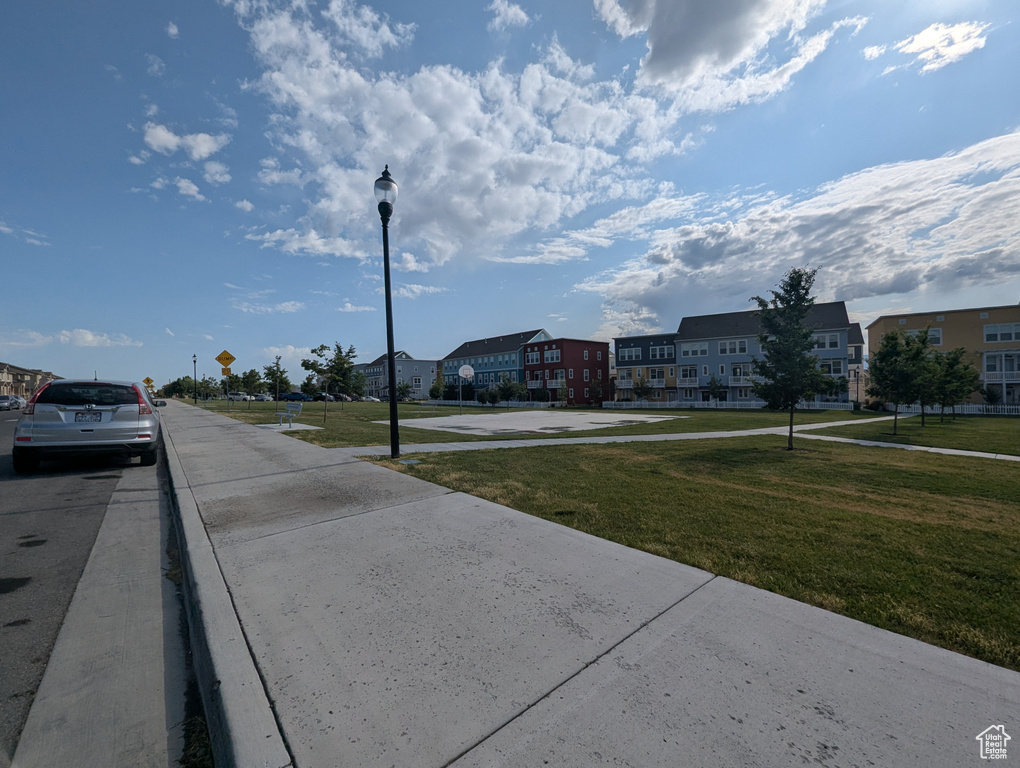 View of street with sidewalks, street lights, and a residential view