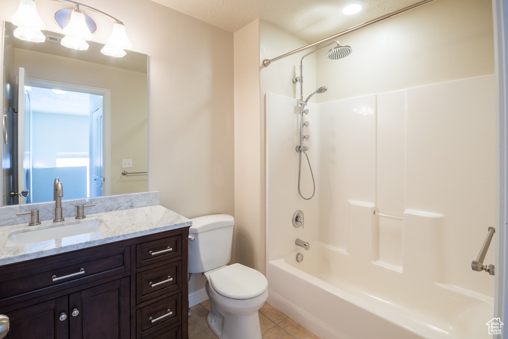Bathroom featuring vanity, tile patterned floors, and shower / bathtub combination