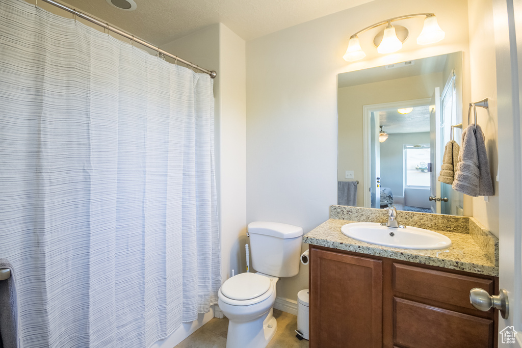 Full bath featuring vanity, tile patterned floors, a shower with curtain, and connected bathroom
