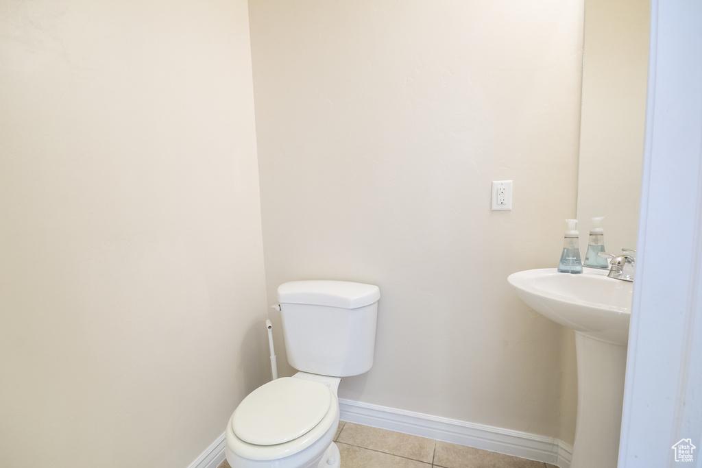 Bathroom featuring tile patterned flooring and toilet