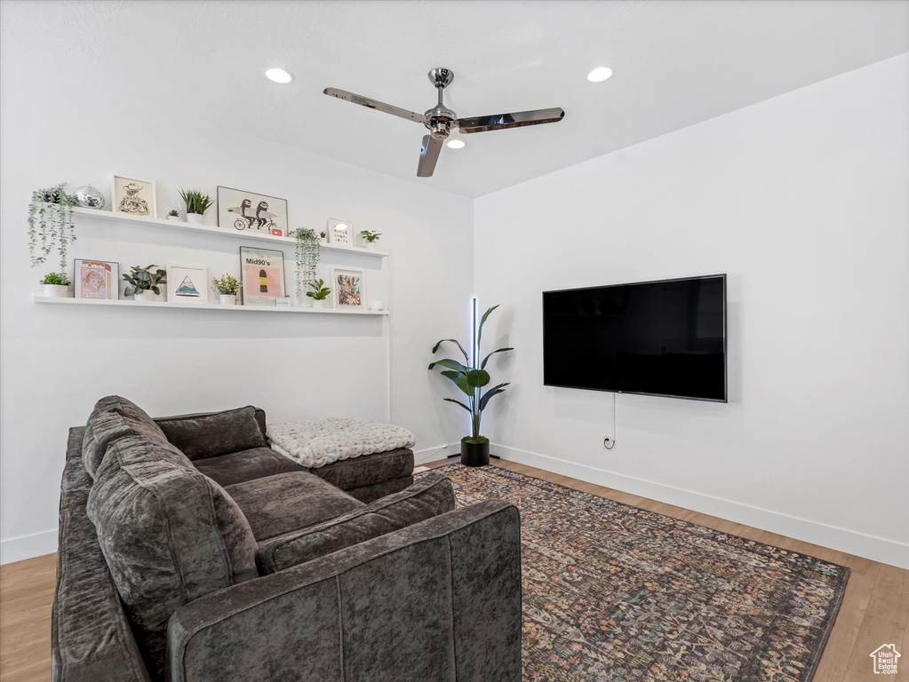 Living room featuring ceiling fan, wood finished floors, and recessed lighting