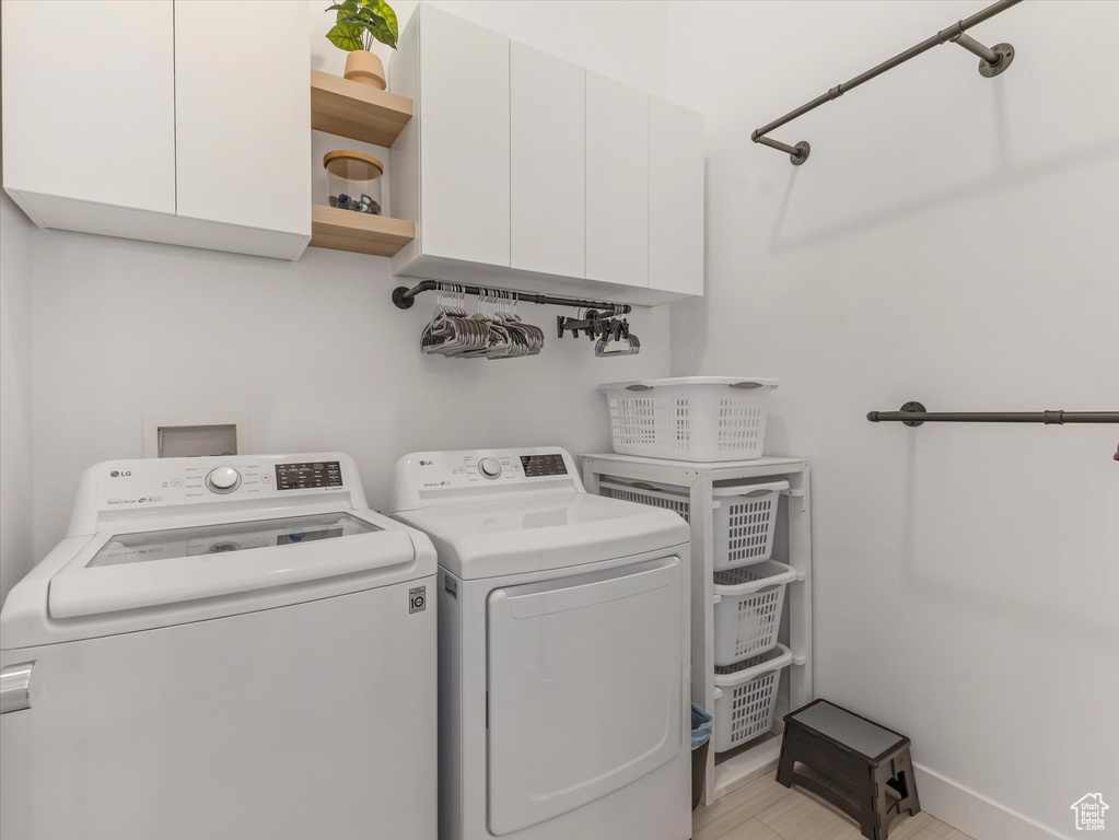 Laundry room featuring cabinet space and washer and dryer