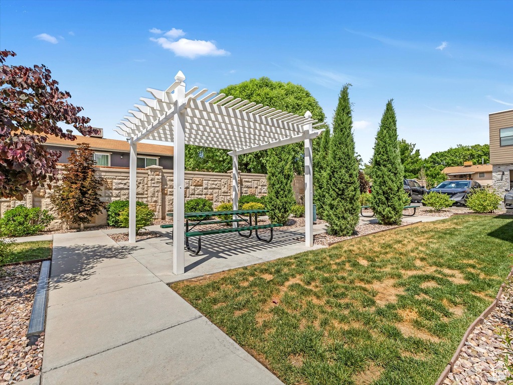 View of home's community featuring a pergola and a patio area