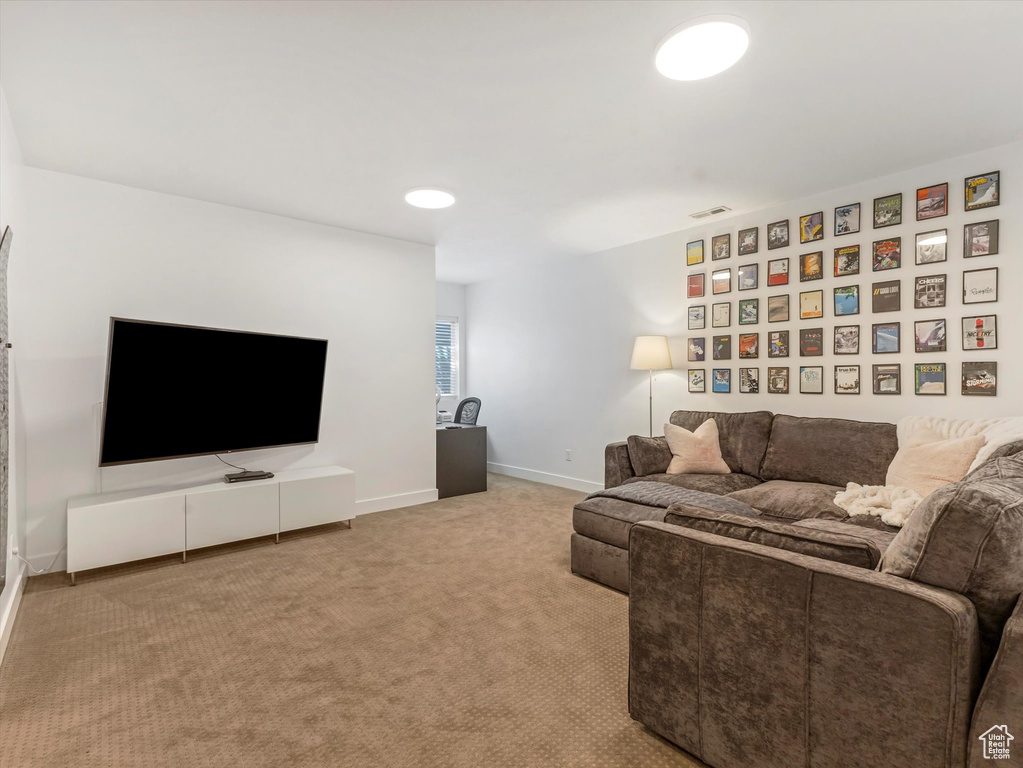 Living room featuring carpet flooring and baseboards