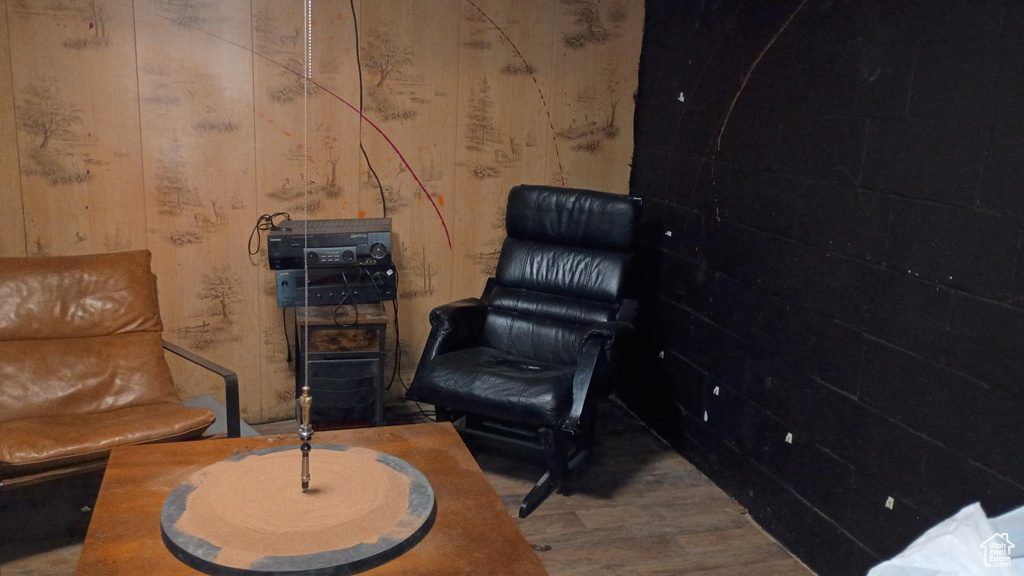Living area with wood finished floors and wood walls