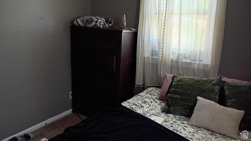 Carpeted bedroom with baseboards