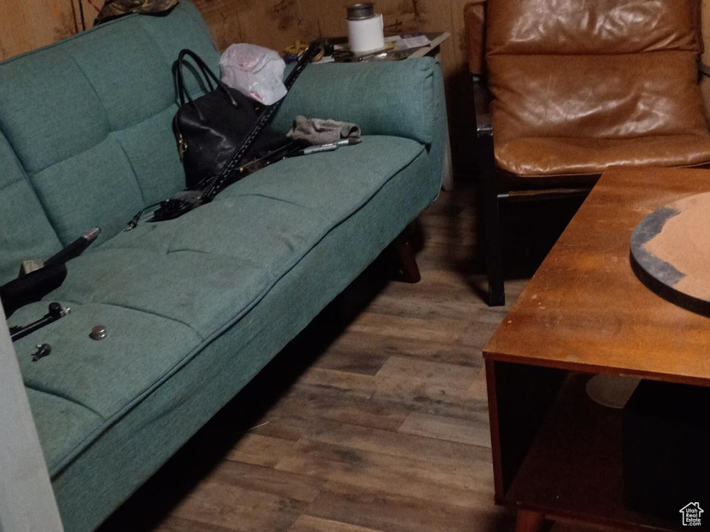 Living area featuring wood walls and wood finished floors