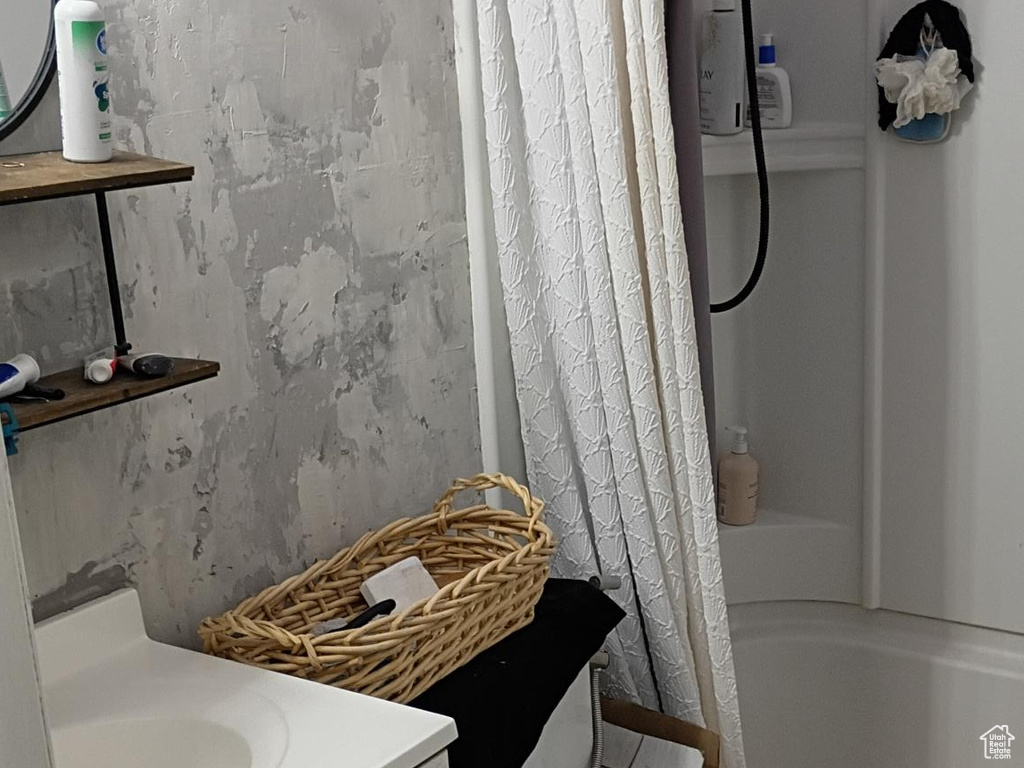 Full bath featuring tile patterned flooring, vanity, and shower / tub combo with curtain