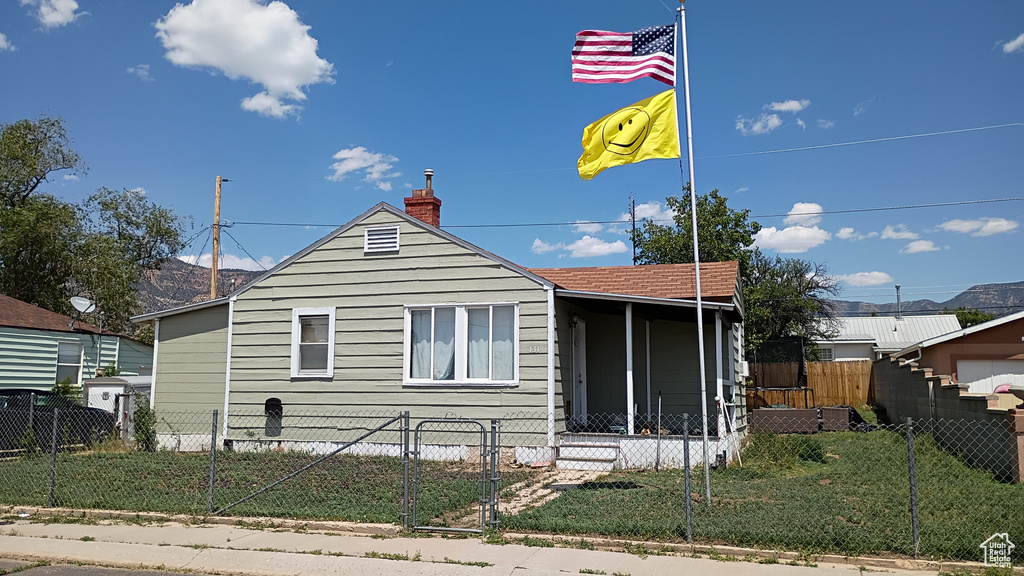 View of front facade with a fenced front yard and a chimney