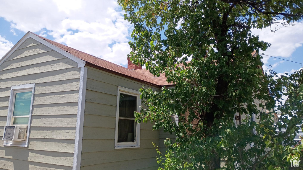 View of property exterior with a chimney