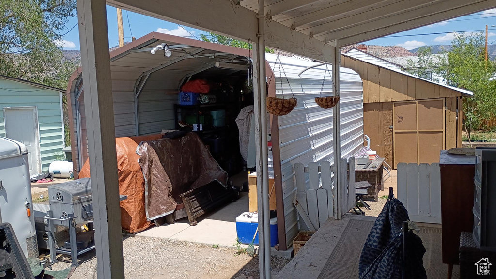 View of outbuilding with a detached carport