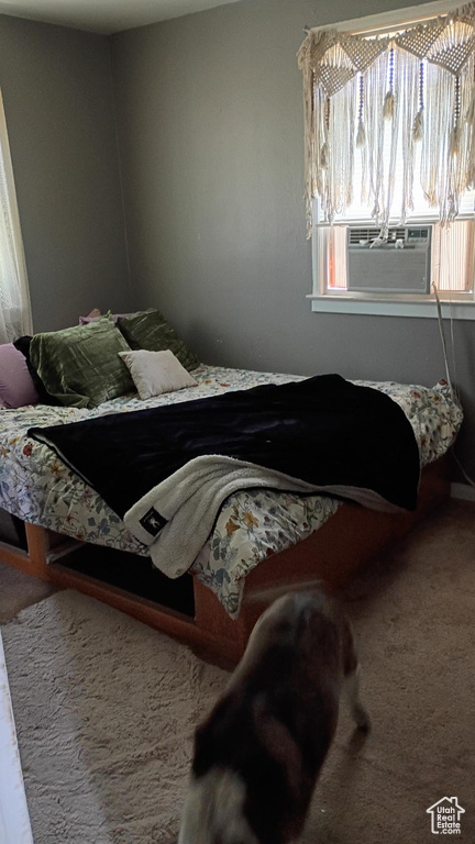 Bedroom featuring cooling unit and carpet flooring