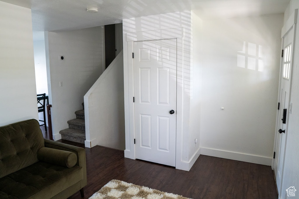 Foyer featuring wood finished floors and stairs
