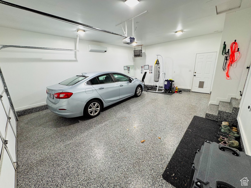 Garage with a garage door opener and a wall mounted AC